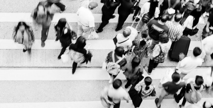 People on a crosswalk in black and white