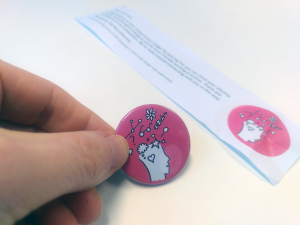 Een Neurodiversiteit illustratie op een button - ontwerpwedstrijd vanuit NWO-I ERG Employee Resource Group - Hoe voelt mijn brein vandaag?